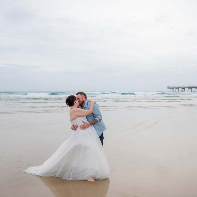 Wedding Photography Micro Elopement bride and groom ambracing on beach