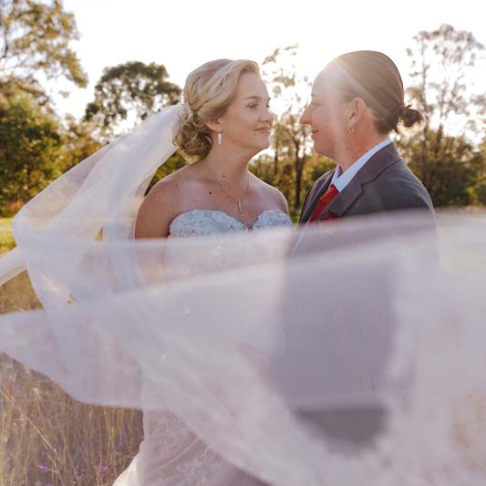 Wedding Photography couple embracing behind veil 1